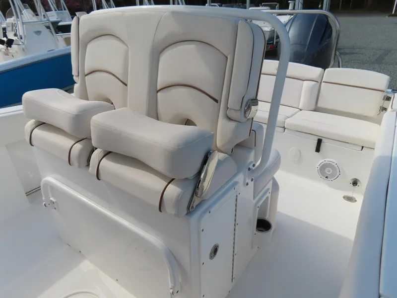 Slide: The Image of 2021 Sea Hunt Ultra 234 boat interior with cushioned seating and storage. - 21