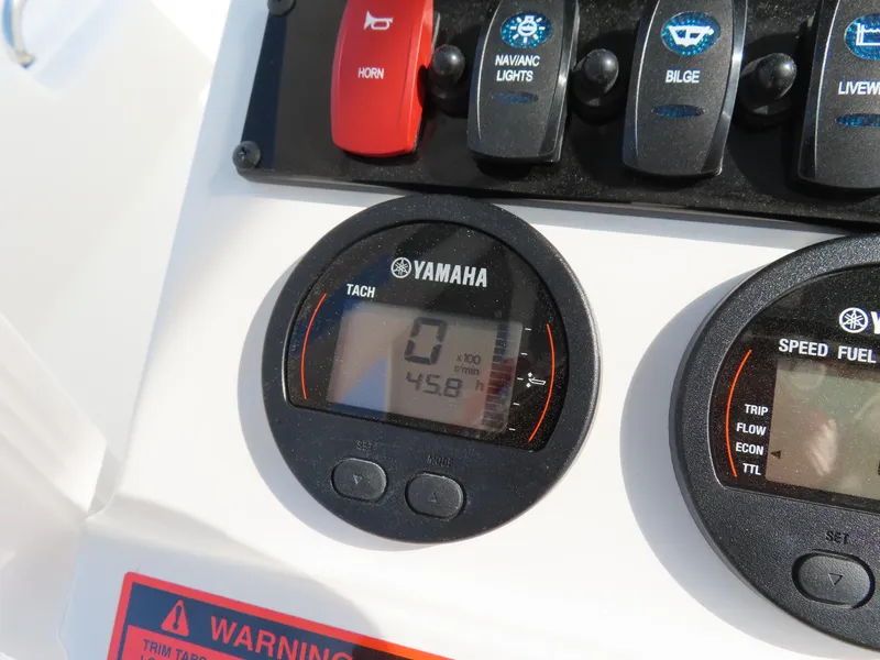 Slide: The Image of Yamaha tachometer and controls on 2021 Sea Hunt Ultra 234 boat dashboard. - 25