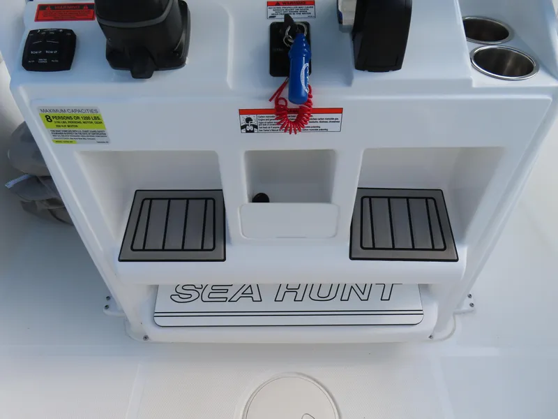 Slide: The Image of 2021 Sea Hunt Ultra 234 boat console with footrests and cup holders. - 26