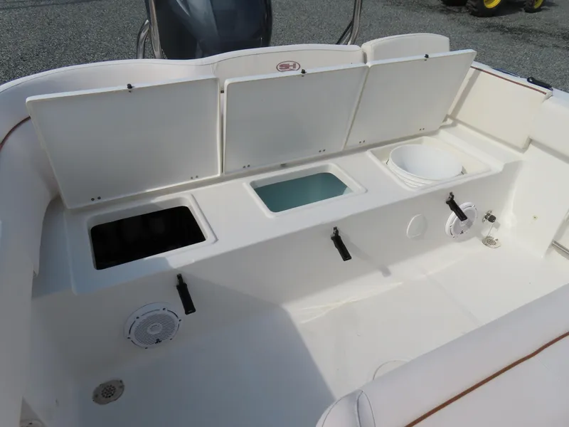 Slide: The Image of 2021 Sea Hunt Ultra 234 boat storage compartments and seating area. - 35