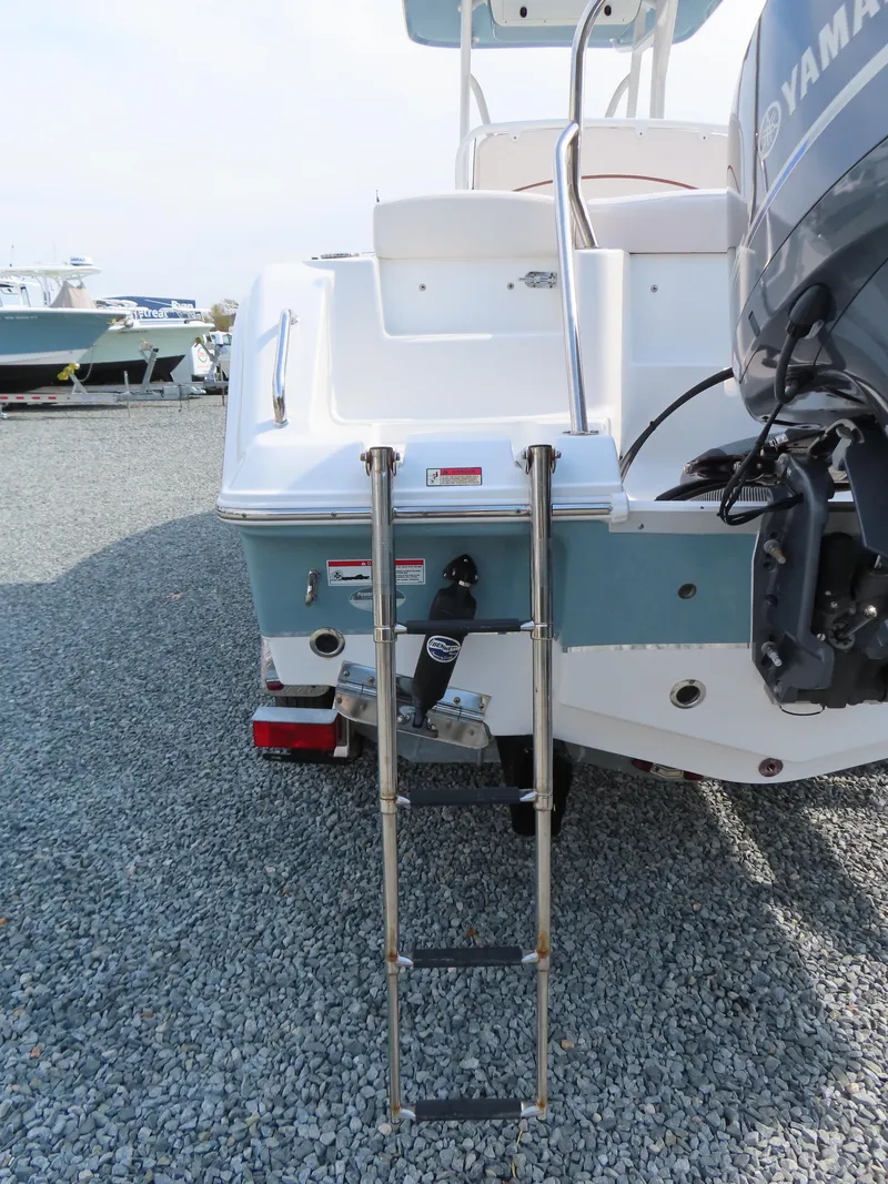 Slide: The Image of 2021 Sea Hunt Ultra 234 boat with ladder and Yamaha outboard motor. - 6