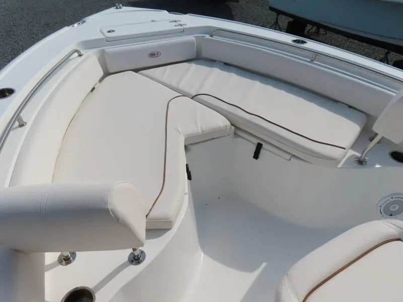 Slide: The Image of 2021 Sea Hunt Ultra 234 boat with white cushioned seating area. - 7