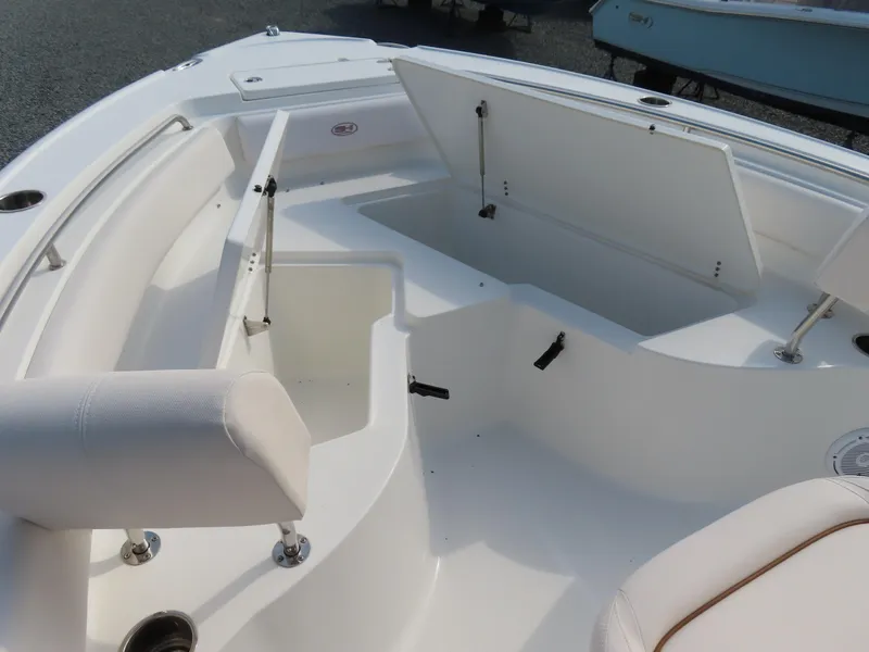 Slide: The Image of 2021 Sea Hunt Ultra 234 boat interior with open storage compartments and seating. - 9