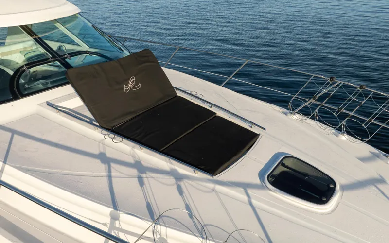 Slide: The Image of 2010 Sea Ray Sundancer yacht deck with sunpad, on calm water. - 18