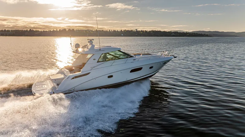 Slide: The Image of 2010 Sea Ray Sundancer cruising on a sunlit lake at sunset. - 20