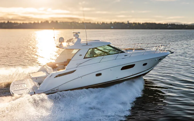 Slide: The Image of 2010 Sea Ray Sundancer yacht cruising on a sunlit lake. - 21