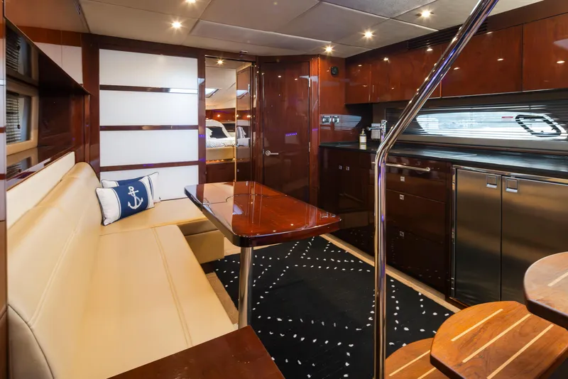 Slide: The Image of Luxurious interior of 2010 Sea Ray Sundancer yacht with elegant seating and modern kitchen. - 29