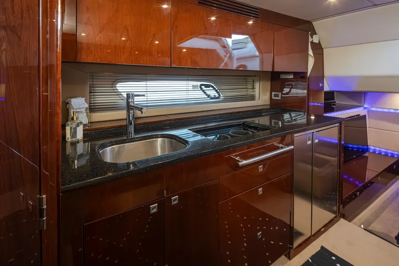 Slide: The Image of Luxurious 2010 Sea Ray Sundancer yacht kitchen with sleek wood cabinetry and modern appliances. - 33