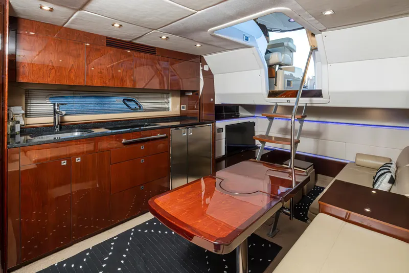 Slide: The Image of Luxurious 2010 Sea Ray Sundancer yacht interior with modern kitchen and seating area. - 34
