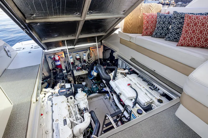 Slide: The Image of Engine compartment of a 2010 Sea Ray Sundancer boat, featuring Cummins engines and seating area. - 46
