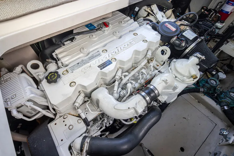 Slide: The Image of Engine compartment of a 2010 Sea Ray Sundancer boat, featuring a Cummins engine. - 49