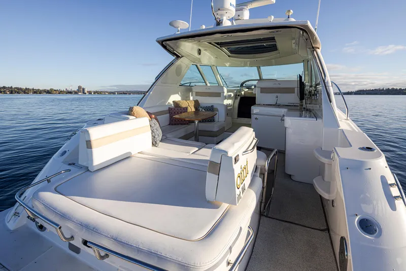 Slide: The Image of 2010 Sea Ray Sundancer yacht interior with seating, on calm water. - 7