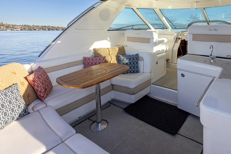 Slide: The Image of Luxurious 2010 Sea Ray Sundancer interior with plush seating and elegant wooden table. - 9