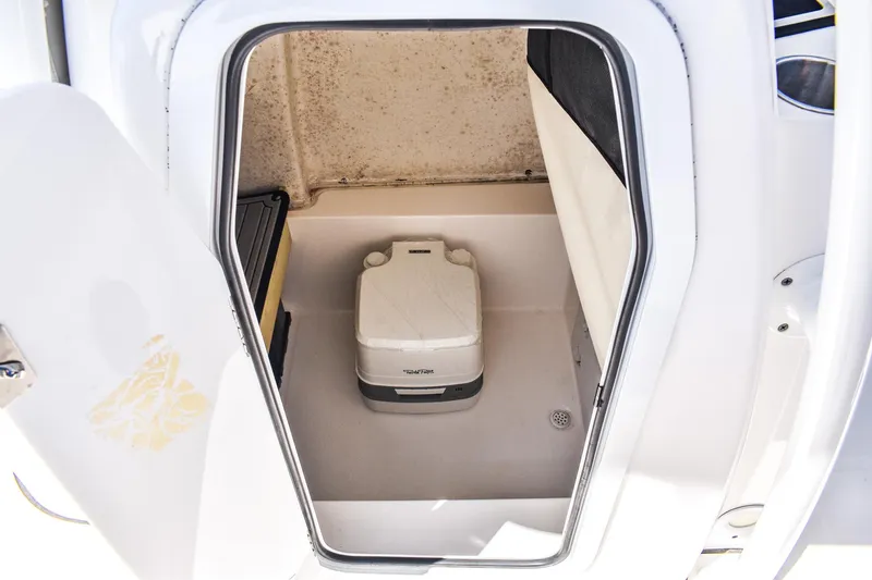 Slide: The Image of 2022 Sea Fox 228 Commander boat interior with portable toilet in storage compartment. - 8