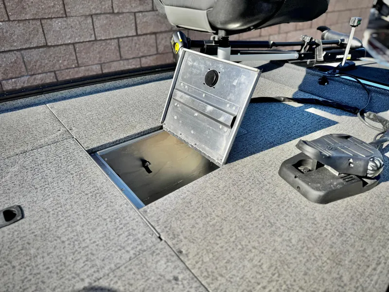 Slide: The Image of 2024 Tracker Pro 170 boat deck with open storage compartment and seat. - 13