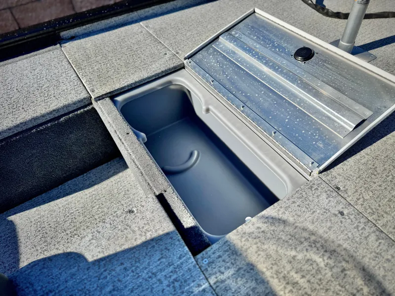 Slide: The Image of 2024 Tracker Pro 170 boat storage compartment with open lid, showcasing interior space. - 14