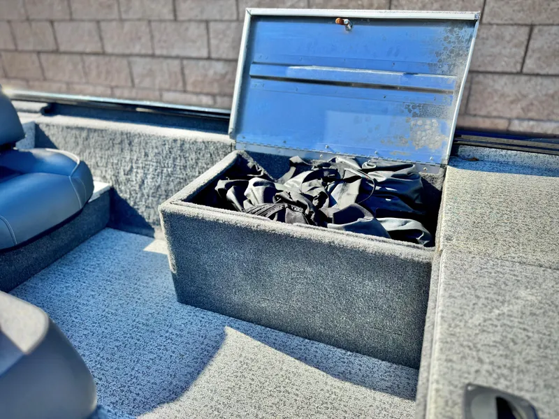Slide: The Image of 2024 Tracker Pro 170 boat storage compartment with open lid, showcasing interior space. - 15