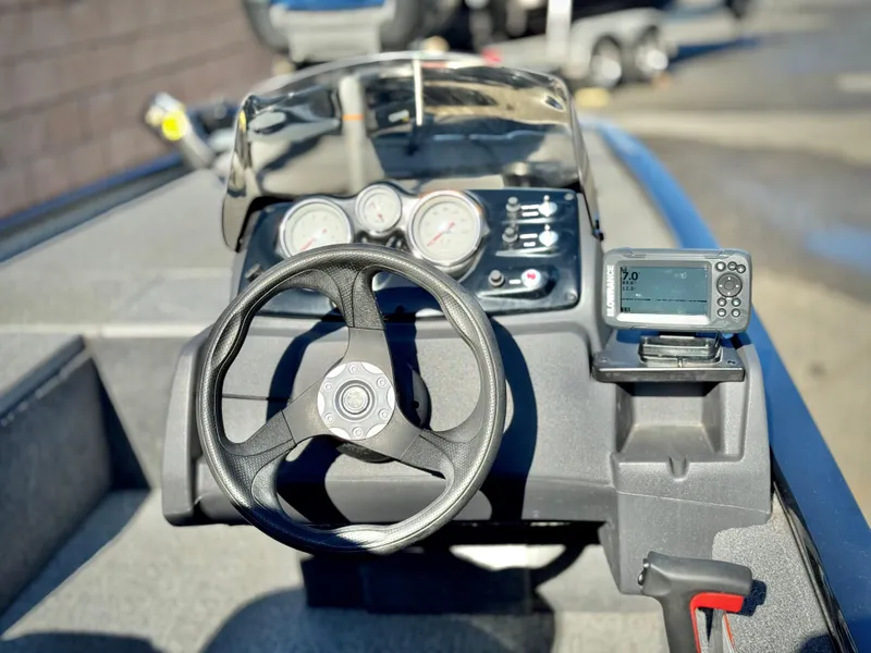 Slide: The Image of 2024 Tracker Pro 170 boat dashboard with steering wheel and gauges. - 20