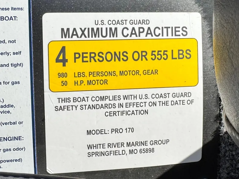 Slide: The Image of 2024 Tracker Pro 170 capacity label: 4 persons or 555 lbs, 50 HP motor. - 23