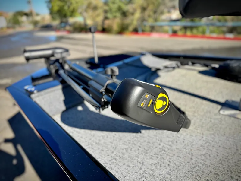 Slide: The Image of 2024 Tracker Pro 170 boat with trolling motor on deck, outdoors. - 8