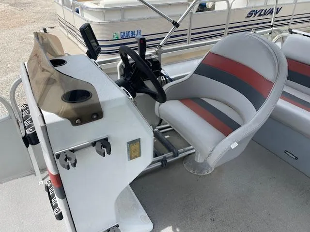 Slide: The Image of Pontoon boat cockpit with steering wheel and cushioned seat, Leisure Island 1992 model. - 10