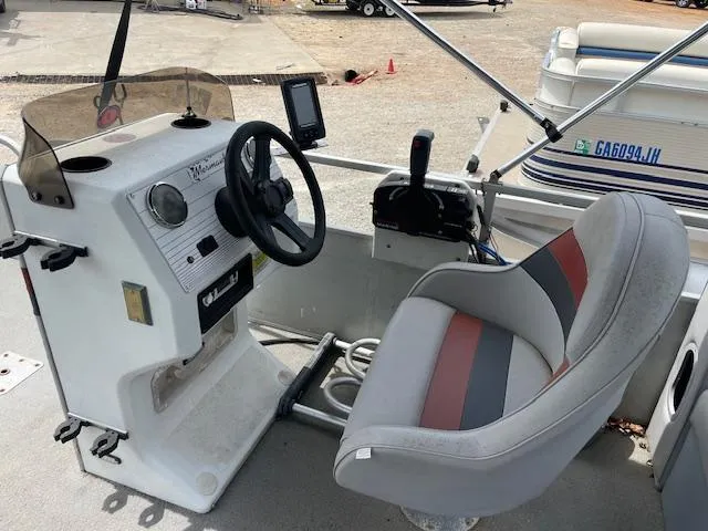 Slide: The Image of 1992 Leisure Island boat cockpit with steering wheel, control panel, and cushioned seat. - 11