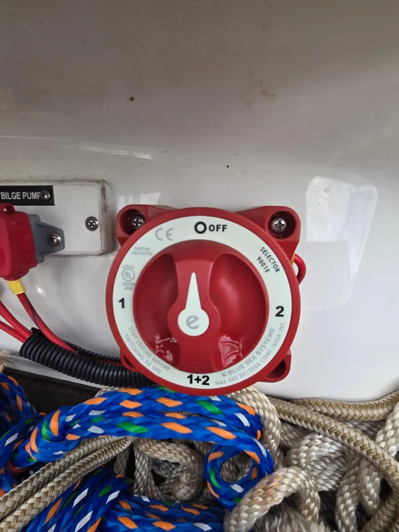 Slide: The Image of Red battery switch on a 2008 Cobalt 220 boat, surrounded by colorful ropes. - 15
