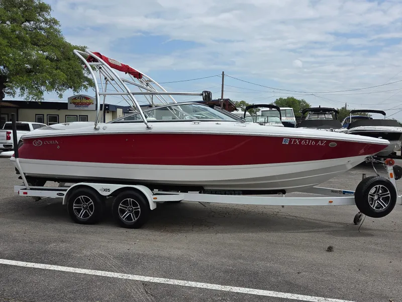 Slide: The Image of 2008 Cobalt 220 boat on trailer, red and white design, parked outdoors. - 5