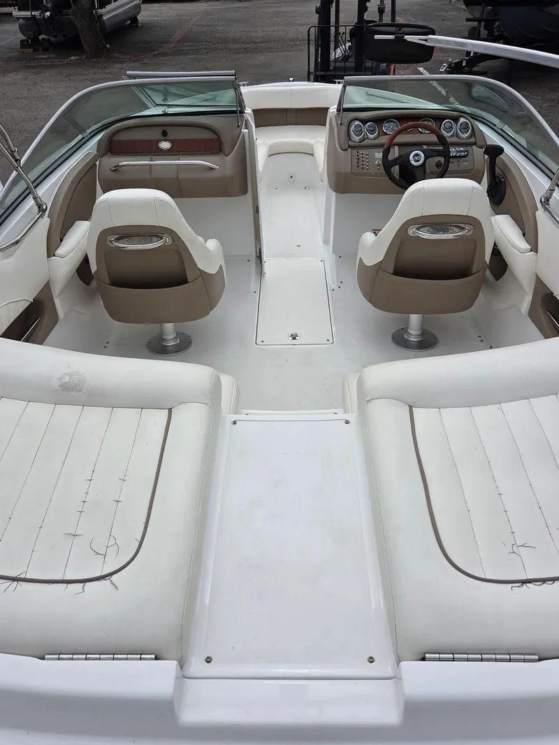 Slide: The Image of 2008 Cobalt 220 boat interior with beige and white seating, steering console, and dashboard. - 7