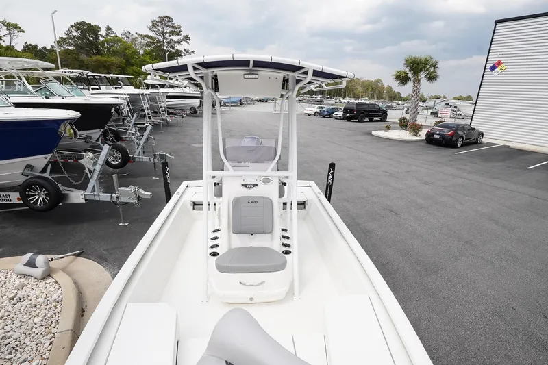 Slide: The Image of 2022 Avid 21 FS boat in a dealership lot, showcasing sleek design and modern features. - 15