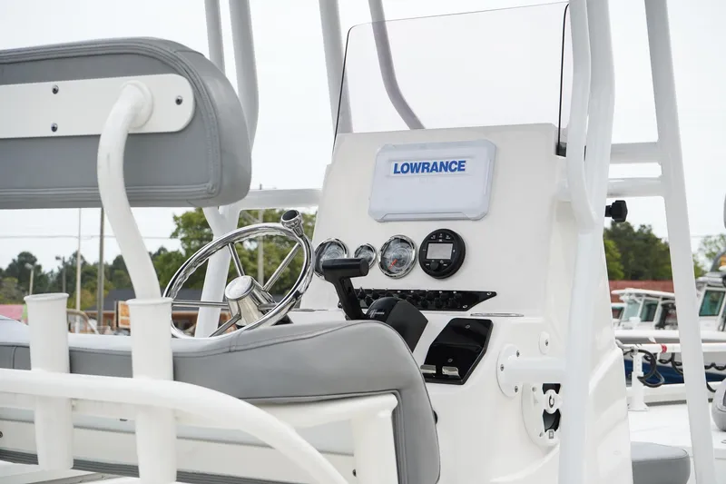 Slide: The Image of 2022 Avid 21 FS boat console with steering wheel and Lowrance electronics. - 7