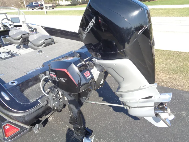 Slide: The Image of 2023 Ranger 621FS Pro boat with Mercury outboard motor, parked on pavement. - 12
