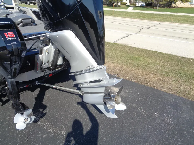 Slide: The Image of 2023 Ranger 621FS Pro boat motor and propeller on pavement. - 16