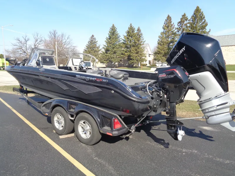 Slide: The Image of 2023 Ranger 621FS Pro boat with Mercury engine on a trailer, parked outdoors. - 18