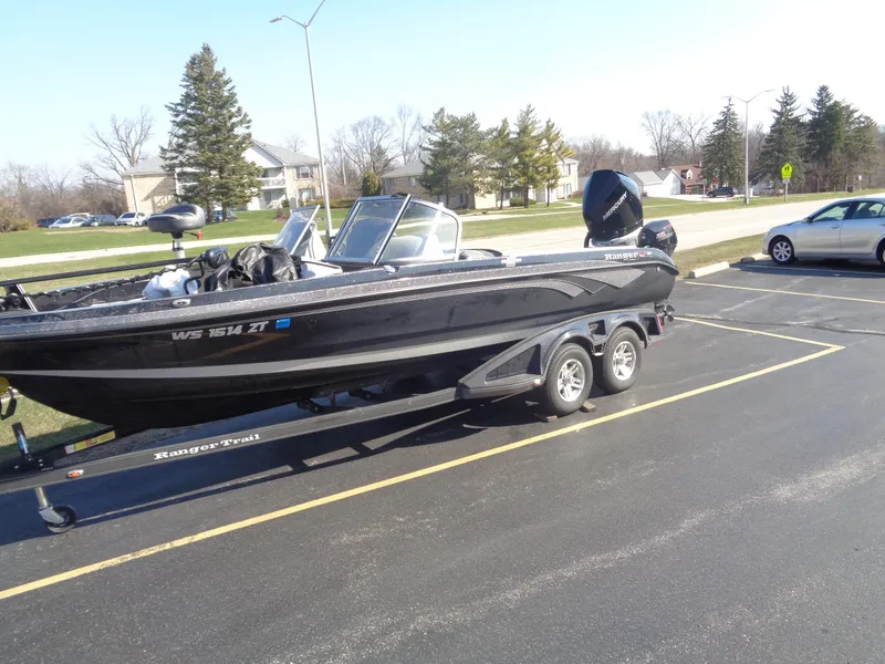 Slide: The Image of 2023 Ranger 621FS Pro boat on trailer in parking lot. - 2