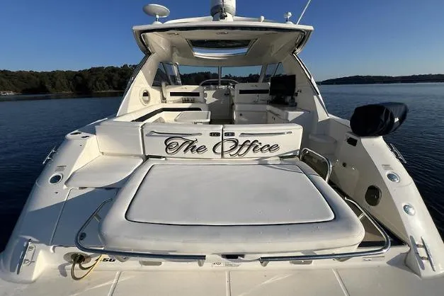 Slide: The Image of 2010 Sea Ray 450 Sundancer yacht, rear view, on calm water. - 11