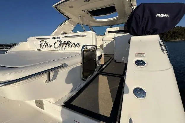 Slide: The Image of 2010 Sea Ray 450 Sundancer yacht named "The Office" with sleek white design. - 14