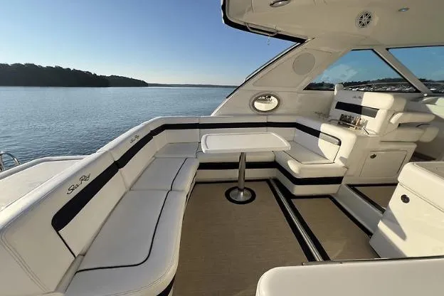 Slide: The Image of Luxurious 2010 Sea Ray 450 Sundancer yacht interior with elegant seating and scenic water view. - 16