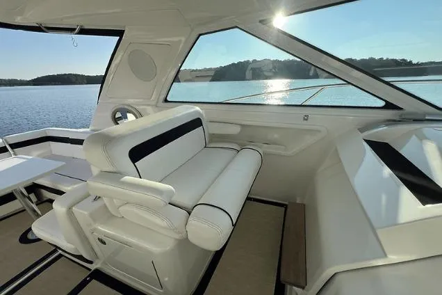 Slide: The Image of Interior of 2010 Sea Ray 450 Sundancer yacht with white seating and scenic water view. - 26