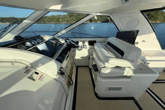 Slide: The Image of Interior of 2010 Sea Ray 450 Sundancer yacht with modern helm and seating. - 27