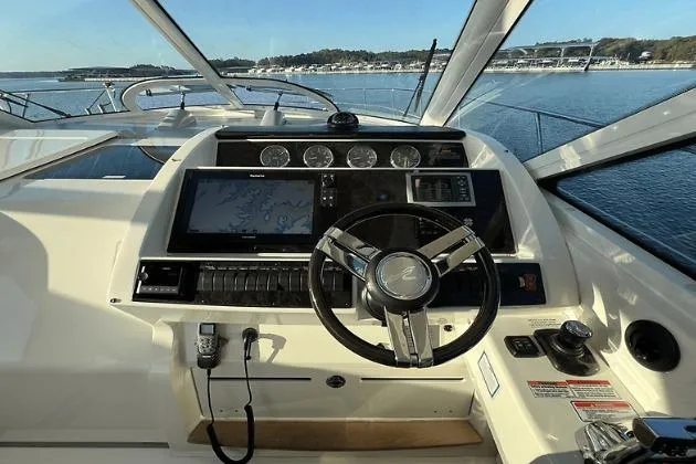 Slide: The Image of Cockpit view of 2010 Sea Ray 450 Sundancer yacht with steering wheel and navigation system. - 29