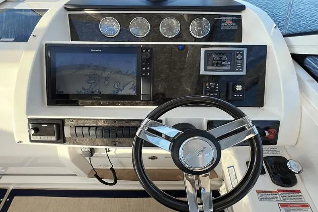 Slide: The Image of 2010 Sea Ray 450 Sundancer helm with navigation system and gauges. - 30