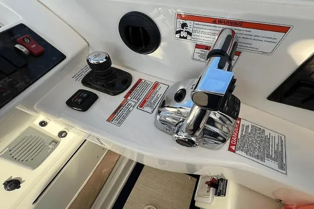 Slide: The Image of Control panel of a 2010 Sea Ray 450 Sundancer boat with throttle and warning labels. - 31