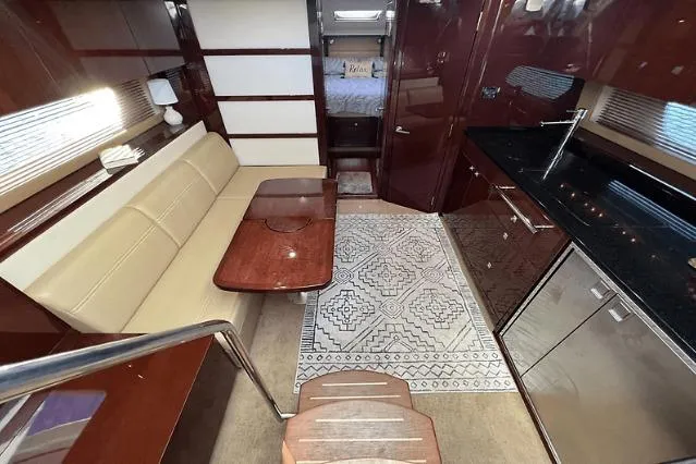 Slide: The Image of Luxurious interior of 2010 Sea Ray 450 Sundancer yacht with elegant seating and modern kitchen. - 40