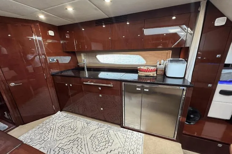 Slide: The Image of Luxurious kitchen interior of 2010 Sea Ray 450 Sundancer yacht with modern amenities. - 44