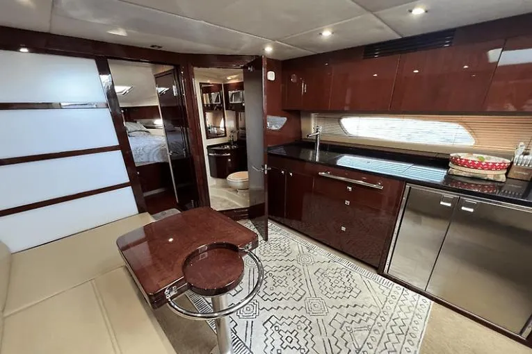 Slide: The Image of Luxurious interior of 2010 Sea Ray 450 Sundancer yacht with modern kitchen and seating area. - 45