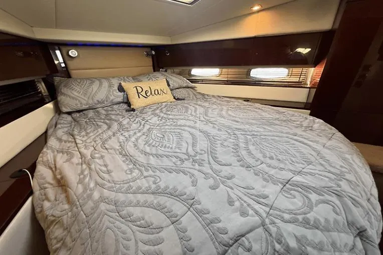 Slide: The Image of Luxurious cabin interior of 2010 Sea Ray 450 Sundancer with cozy bedding and "Relax" pillow. - 49