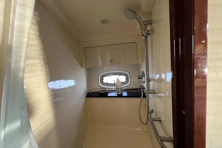 Slide: The Image of Luxurious bathroom in 2010 Sea Ray 450 Sundancer yacht with shower and porthole window. - 50