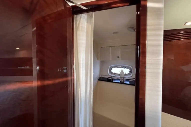 Slide: The Image of Interior view of 2010 Sea Ray 450 Sundancer yacht bathroom with wood finish. - 51
