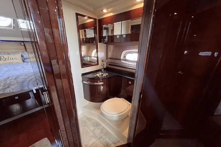 Slide: The Image of Luxurious bathroom interior of 2010 Sea Ray 450 Sundancer yacht, featuring elegant wood finishes. - 52